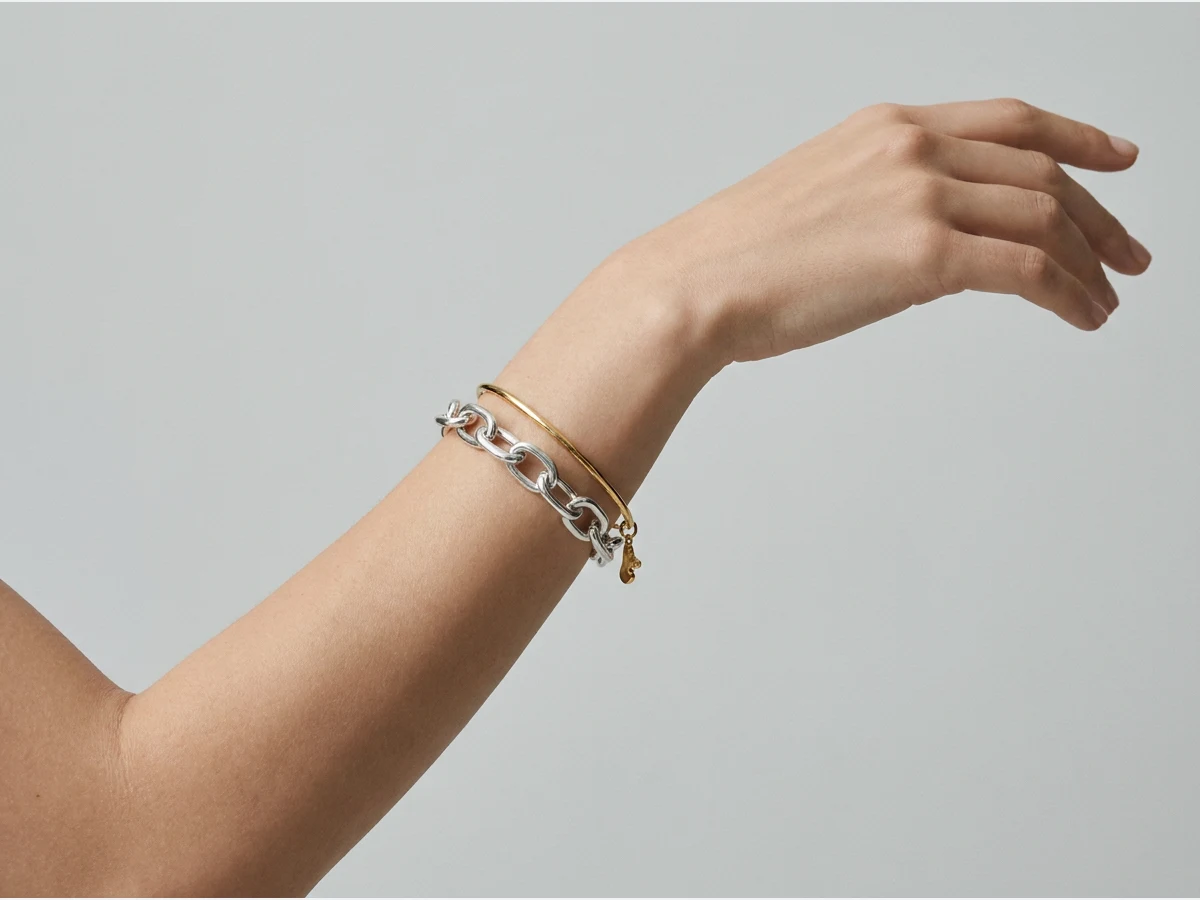 a model photographed to show a bracelet on the wrist, two bracelets stacked