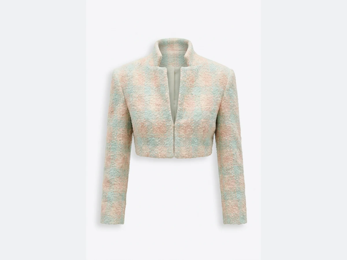 A pastel tweed cropped jacket photographed flat, the product the model is built from