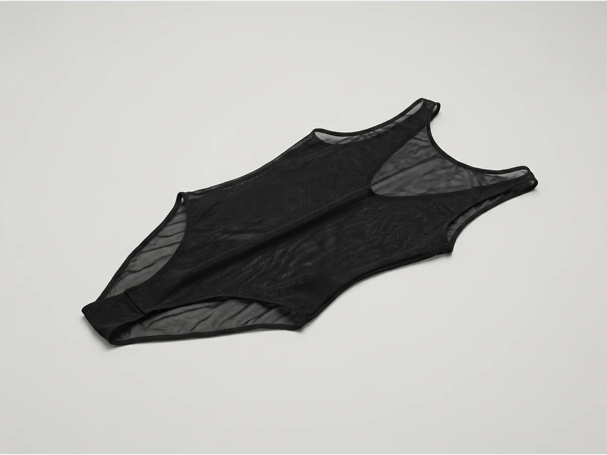 a lingerie set, product shot on a plain ground, a bodysuit in black mesh