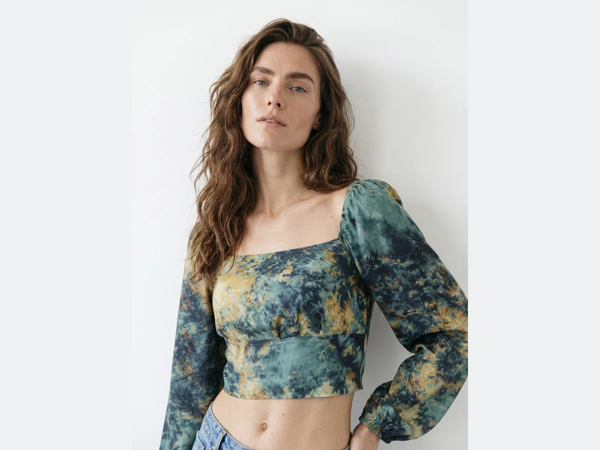A model photographed wearing a tie dye cropped top, the image the fabric is swapped on