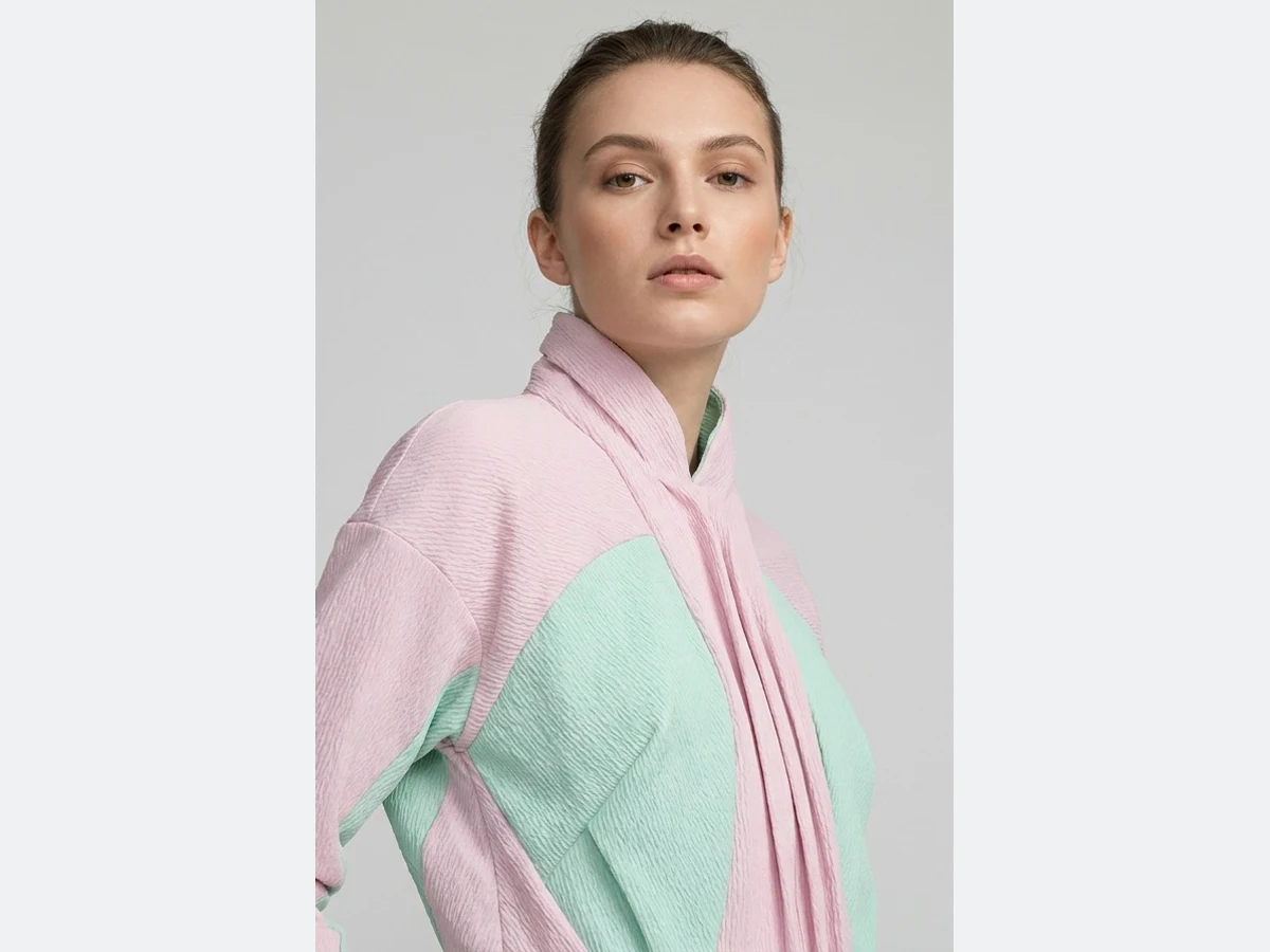 A model wearing the pink and mint panelled jacket, the photograph the swap starts from