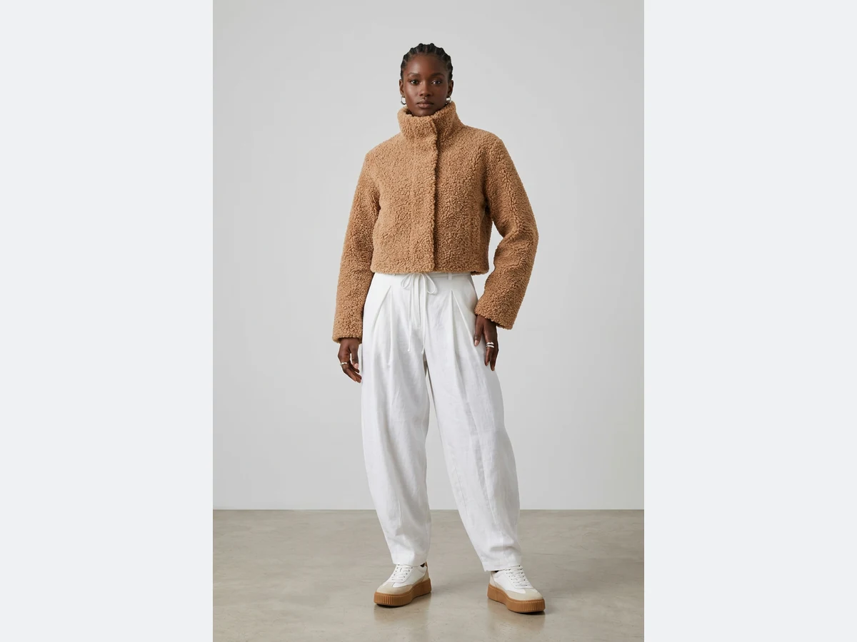 A model wearing a cropped jacket cut from that fabric, generated from the swatch alone