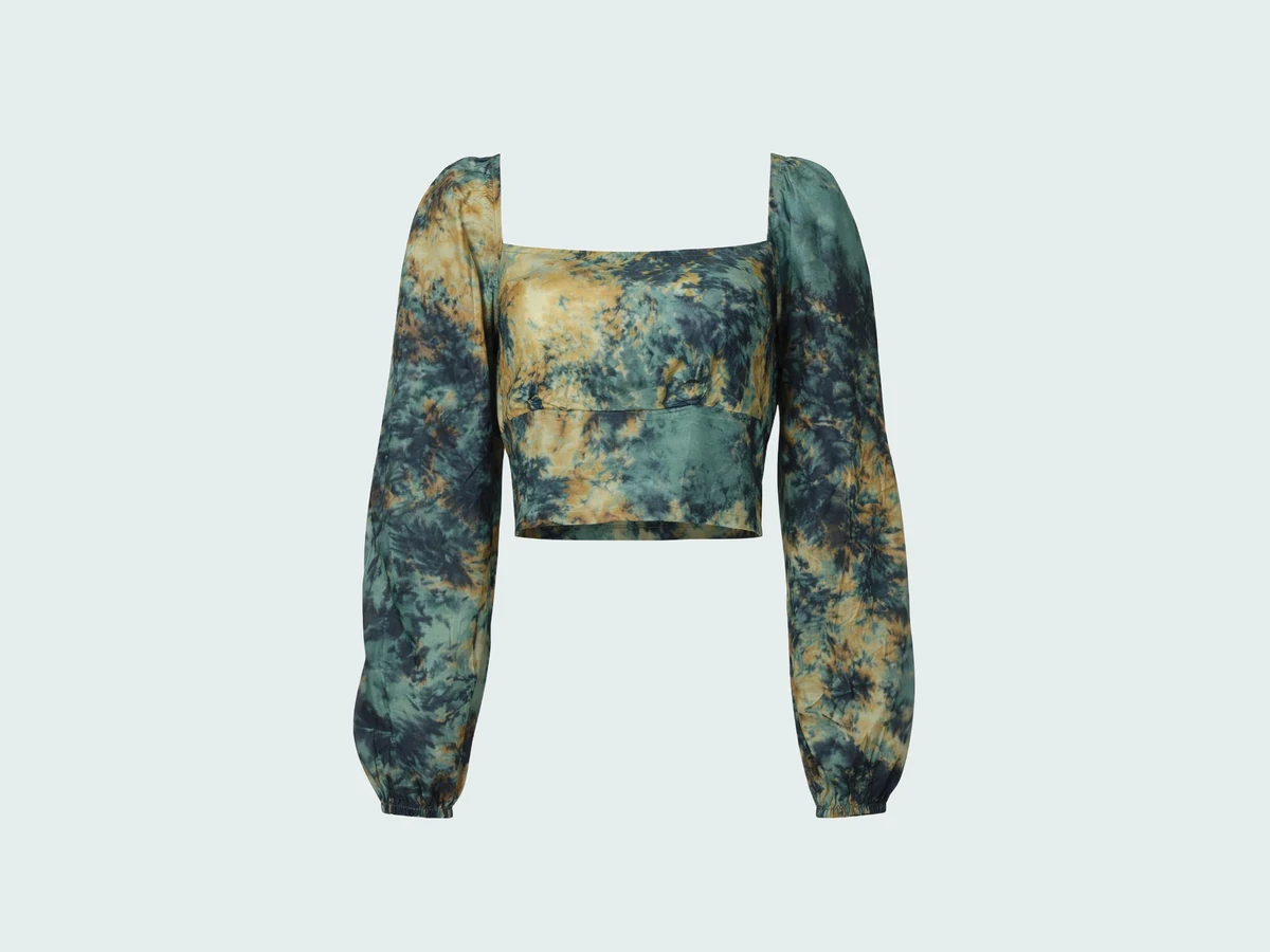 A cropped tie dye top with a square neckline and puff sleeves, shot flat as a product photo